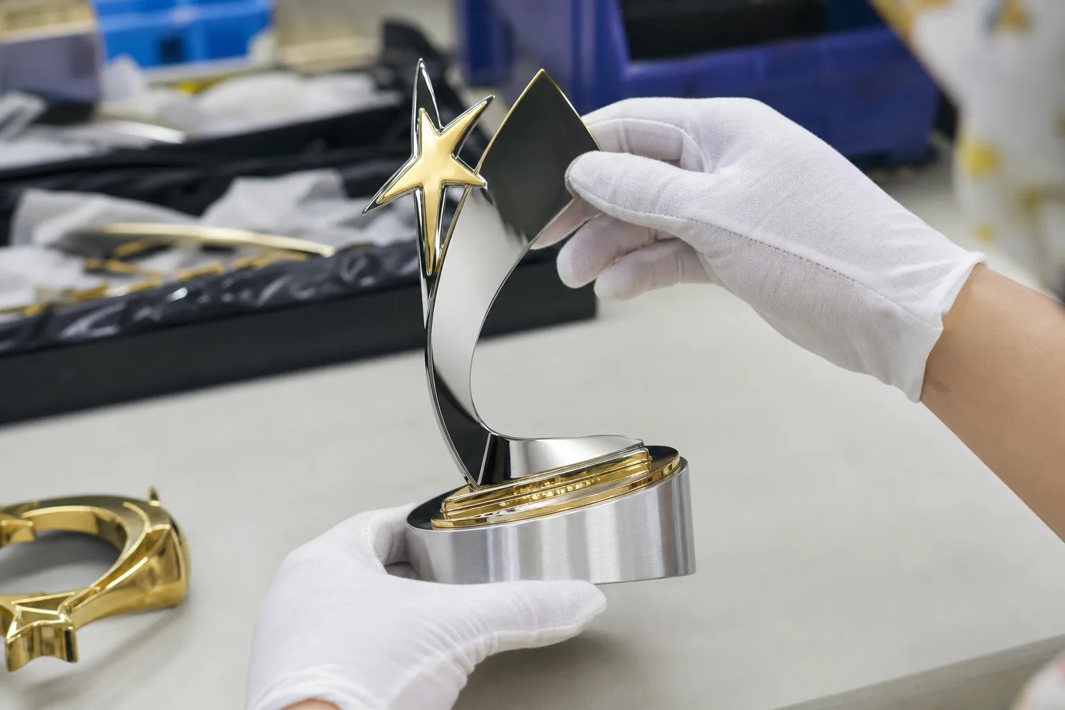 Inspecting a custom metal trophy finish sample
