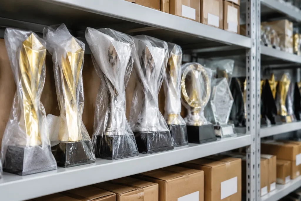Labeled and protected custom metal trophy samples stored in a controlled quality archive area